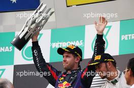 Race winner Sebastian Vettel (GER) Red Bull Racing celebrates on the podium. 24.03.2013. Formula 1 World Championship, Rd 2, Malaysian Grand Prix, Sepang, Malaysia, Sunday.