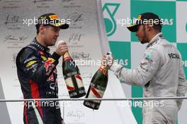 (L to R): Sebastian Vettel (GER) Red Bull Racing with Lewis Hamilton (GBR) Mercedes AMG F1 on the podium. 24.03.2013. Formula 1 World Championship, Rd 2, Malaysian Grand Prix, Sepang, Malaysia, Sunday.
