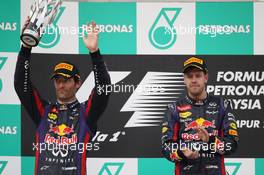 Second placed Mark Webber (AUS) Red Bull Racing celebrates his second position on the podium with race winner Sebastian Vettel (GER) Red Bull Racing. 24.03.2013. Formula 1 World Championship, Rd 2, Malaysian Grand Prix, Sepang, Malaysia, Sunday.
