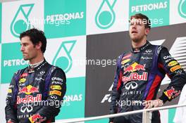 (L to R): second placed Mark Webber (AUS) Red Bull Racing and team mate, race winner Sebastian Vettel (GER) Red Bull Racing, on the podium. 24.03.2013. Formula 1 World Championship, Rd 2, Malaysian Grand Prix, Sepang, Malaysia, Sunday.