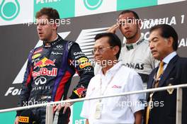 (L to R): Race winner Sebastian Vettel (GER) Red Bull Racing and Lewis Hamilton (GBR) Mercedes AMG F1 on the podium. 24.03.2013. Formula 1 World Championship, Rd 2, Malaysian Grand Prix, Sepang, Malaysia, Sunday.