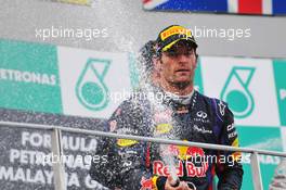 Mark Webber (AUS) Red Bull Racing RB9 celebrates his 22 position on the podium. 24.03.2013. Formula 1 World Championship, Rd 2, Malaysian Grand Prix, Sepang, Malaysia, Sunday.
