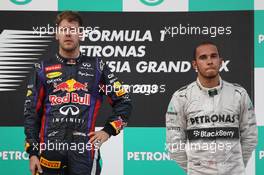 (L to R): Race winner Sebastian Vettel (GER) Red Bull Racing on the podium with third placed Lewis Hamilton (GBR) Mercedes AMG F1. 24.03.2013. Formula 1 World Championship, Rd 2, Malaysian Grand Prix, Sepang, Malaysia, Sunday.