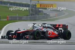 Jenson Button (GBR) McLaren MP4-28 and Nico Rosberg (GER) Mercedes AMG F1 W04 battle for position. 24.03.2013. Formula 1 World Championship, Rd 2, Malaysian Grand Prix, Sepang, Malaysia, Sunday.