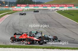 Jules Bianchi (FRA) Marussia F1 Team MR02 and Lewis Hamilton (GBR) Mercedes AMG F1 W04. 24.03.2013. Formula 1 World Championship, Rd 2, Malaysian Grand Prix, Sepang, Malaysia, Sunday.