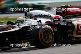 Kimi Raikkonen (FIN) Lotus F1 E21 and Sergio Perez (MEX) McLaren MP4-28. 24.03.2013. Formula 1 World Championship, Rd 2, Malaysian Grand Prix, Sepang, Malaysia, Sunday.