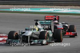 Nico Rosberg (GER) Mercedes AMG F1 W04 leads Jenson Button (GBR) McLaren MP4-28. 24.03.2013. Formula 1 World Championship, Rd 2, Malaysian Grand Prix, Sepang, Malaysia, Sunday.