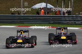 Sebastian Vettel (GER) Red Bull Racing RB9 and team mate Mark Webber (AUS) Red Bull Racing RB9 battle for the lead of the race. 24.03.2013. Formula 1 World Championship, Rd 2, Malaysian Grand Prix, Sepang, Malaysia, Sunday.