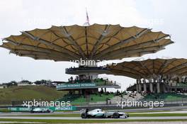 Nico Rosberg (GER) Mercedes AMG F1 W04 enters the pits as Lewis Hamilton (GBR) Mercedes AMG F1 W04 passes. 23.03.2013. Formula 1 World Championship, Rd 2, Malaysian Grand Prix, Sepang, Malaysia, Saturday.