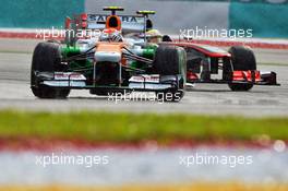 Adrian Sutil (GER) Sahara Force India VJM06 leads Sergio Perez (MEX) McLaren MP4-28. 23.03.2013. Formula 1 World Championship, Rd 2, Malaysian Grand Prix, Sepang, Malaysia, Saturday.