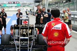 Andrea Stella (ITA) Ferrari Race Engineer takes a look at the Lotus F1 E21. 21.03.2013. Formula 1 World Championship, Rd 2, Malaysian Grand Prix, Sepang, Malaysia, Thursday.