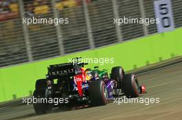 Sebastian Vettel (GER) Red Bull Racing RB9 passes Charles Pic (FRA) Caterham CT03 with sparks flying. 20.09.2013. Formula 1 World Championship, Rd 13, Singapore Grand Prix, Singapore, Singapore, Practice Day.