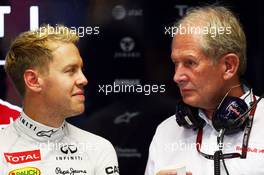 (L to R): Sebastian Vettel (GER) Red Bull Racing with Dr Helmut Marko (AUT) Red Bull Motorsport Consultant. 20.09.2013. Formula 1 World Championship, Rd 13, Singapore Grand Prix, Singapore, Singapore, Practice Day.