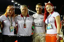 (L to R): Sasha Cheglakov (RUS) Marussia Team Owner; Andrei Cheglakov (RUS) Marussia Team Owner; Jules Bianchi (FRA) Marussia F1 Team and Anya Cheglakov (RUS) on the grid. 22.09.2013. Formula 1 World Championship, Rd 13, Singapore Grand Prix, Singapore, Singapore, Race Day.