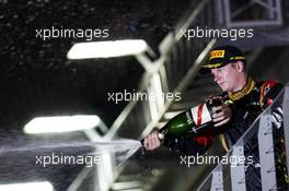 Kimi Raikkonen (FIN) Lotus F1 Team celebrates his third position with the champagne on the podium. 22.09.2013. Formula 1 World Championship, Rd 13, Singapore Grand Prix, Singapore, Singapore, Race Day.