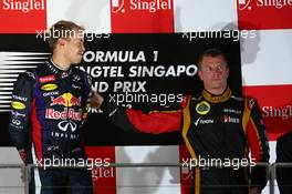 Sebastian Vettel (GER) Red Bull Racing and Kimi Raikkonen (FIN) Lotus F1 Team. 22.09.2013. Formula 1 World Championship, Rd 13, Singapore Grand Prix, Singapore, Singapore, Race Day.