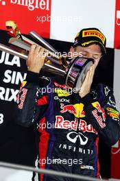 Race winner Sebastian Vettel (GER) Red Bull Racing celebrates on the podium. 22.09.2013. Formula 1 World Championship, Rd 13, Singapore Grand Prix, Singapore, Singapore, Race Day.