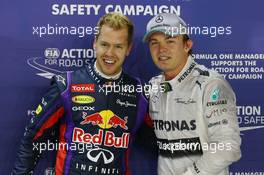 (L to R): pole sitter Sebastian Vettel (GER) Red Bull Racing with second placed Nico Rosberg (GER) Mercedes AMG F1 in parc ferme. 21.09.2013. Formula 1 World Championship, Rd 13, Singapore Grand Prix, Singapore, Singapore, Qualifying Day.