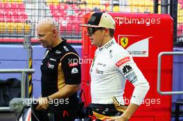 Kimi Raikkonen (FIN) Lotus F1 Team with Mark Arnall (GBR) Personal Trainer.