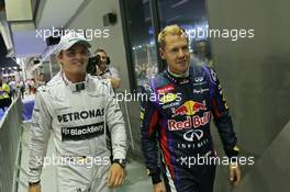 (L to R): Nico Rosberg (GER) Mercedes AMG F1 with pole sitter Sebastian Vettel (GER) Red Bull Racing in parc ferme. 21.09.2013. Formula 1 World Championship, Rd 13, Singapore Grand Prix, Singapore, Singapore, Qualifying Day.