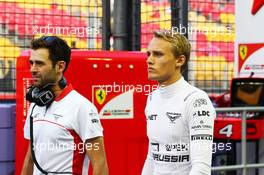 Max Chilton (GBR) Marussia F1 Team with Sam Village (GBR) Marussia F1 Team.