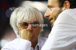 (L to R): Bernie Ecclestone (GBR) CEO Formula One Group (FOM) with Matteo Bonciani (ITA) FIA Media Delegate. 22.09.2013. Formula 1 World Championship, Rd 13, Singapore Grand Prix, Singapore, Singapore, Race Day.
