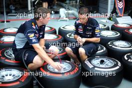 Red Bull Racing mechanics mark up Pirelli tyres. 19.09.2013. Formula 1 World Championship, Rd 13, Singapore Grand Prix, Singapore, Singapore, Preparation Day.