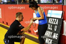 Romance in the paddock as Kerry Arnold (GBR) Red Bull Racing Hospitality Manager accepts a marriage proposal from Nick Hayes (GBR) Lotus F1 Team employee. 19.09.2013. Formula 1 World Championship, Rd 13, Singapore Grand Prix, Singapore, Singapore, Preparation Day.