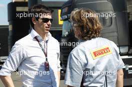 Toto Wolff (GER) Mercedes AMG F1 Shareholder and Executive Director (Left) with a Pirelli employee. 19.07.2013. Formula One Young Drivers Test, Day 3, Silverstone, England.