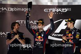 Mark Webber (AUS) Red Bull Racing celebrates his second position on the podium with race winner Sebastian Vettel (GER) Red Bull Racing (Right) and Gavin Ward (CDN) Red Bull Racing Race Engineer (Left). 03.11.2013. Formula 1 World Championship, Rd 17, Abu Dhabi Grand Prix, Yas Marina Circuit, Abu Dhabi, Race Day.