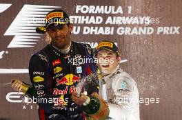 Nico Rosberg (GER) Mercedes AMG F1 W04 celebrates his third position on the podium with second placed Mark Webber (AUS) Red Bull Racing. 03.11.2013. Formula 1 World Championship, Rd 17, Abu Dhabi Grand Prix, Yas Marina Circuit, Abu Dhabi, Race Day.