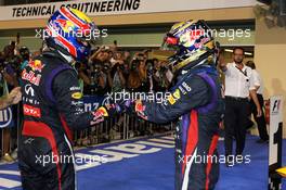 (L to R): Second placed Mark Webber (AUS) Red Bull Racing congratulates team mate, race winner, Sebastian Vettel (GER) Red Bull Racing, in parc ferme. 03.11.2013. Formula 1 World Championship, Rd 17, Abu Dhabi Grand Prix, Yas Marina Circuit, Abu Dhabi, Race Day.