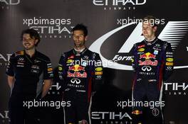 The podium (L to R): Gavin Ward (CDN) Red Bull Racing Race Engineer; second placed Mark Webber (AUS) Red Bull Racing with race winner Sebastian Vettel (GER) Red Bull Racing. 03.11.2013. Formula 1 World Championship, Rd 17, Abu Dhabi Grand Prix, Yas Marina Circuit, Abu Dhabi, Race Day.