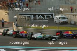 Nico Rosberg (GER) Mercedes AMG F1 W04 passes Mark Webber (AUS) Red Bull Racing RB9 at the start of the race. 03.11.2013. Formula 1 World Championship, Rd 17, Abu Dhabi Grand Prix, Yas Marina Circuit, Abu Dhabi, Race Day.