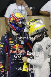 (L to R): Mark Webber (AUS) Red Bull Racing celebrates his pole position in parc ferme with Nico Rosberg (GER) Mercedes AMG F1. 02.11.2013. Formula 1 World Championship, Rd 17, Abu Dhabi Grand Prix, Yas Marina Circuit, Abu Dhabi, Qualifying Day.
