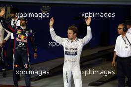 (L to R): Mark Webber (AUS) Red Bull Racing celebrates his pole position in parc ferme with third placed Nico Rosberg (GER) Mercedes AMG F1. 02.11.2013. Formula 1 World Championship, Rd 17, Abu Dhabi Grand Prix, Yas Marina Circuit, Abu Dhabi, Qualifying Day.
