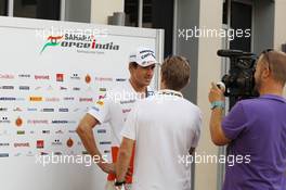 Adrian Sutil (GER) Sahara Force India F1 with the media. 31.10.2013. Formula 1 World Championship, Rd 17, Abu Dhabi Grand Prix, Yas Marina Circuit, Abu Dhabi, Preparation Day.