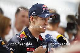 Sebastian Vettel (GER) Red Bull Racing with the media. 31.10.2013. Formula 1 World Championship, Rd 17, Abu Dhabi Grand Prix, Yas Marina Circuit, Abu Dhabi, Preparation Day.