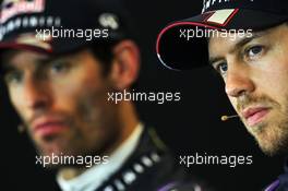 Sebastian Vettel (GER) Red Bull Racing and team mate Mark Webber (AUS) Red Bull Racing in the FIA Press Conference. 16.11.2013. Formula 1 World Championship, Rd 18, United States Grand Prix, Austin, Texas, USA, Qualifying Day.