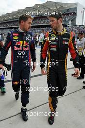 (L to R): pole sitter Sebastian Vettel (GER) Red Bull Racing with third placed Romain Grosjean (FRA) Lotus F1 Team in qualifying parc ferme. 16.11.2013. Formula 1 World Championship, Rd 18, United States Grand Prix, Austin, Texas, USA, Qualifying Day.