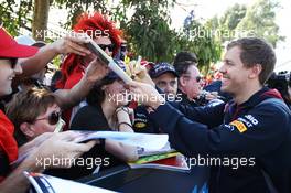Sebastian Vettel (GER) Red Bull Racing signs autographs for the fans. 14.03.2014. Formula 1 World Championship, Rd 1, Australian Grand Prix, Albert Park, Melbourne, Australia, Practice Day.