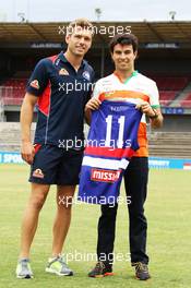 (L to R): Shaun Higgins (AUS) Western Bulldogs Australian Rules Footballer presents a team jersey to Sergio Perez (MEX) Sahara Force India F1 at Whitten Oval. 11.03.2014. Formula 1 World Championship, Rd 1, Australian Grand Prix, Albert Park, Melbourne, Australia, Preparation Day.