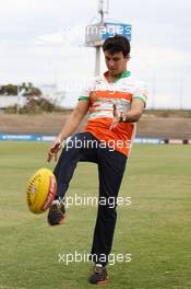 Sergio Perez (MEX) Sahara Force India F1 practices his Australian Rules Football skills with the Western Bulldogs at Whitten Oval. 11.03.2014. Formula 1 World Championship, Rd 1, Australian Grand Prix, Albert Park, Melbourne, Australia, Preparation Day.