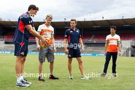 Nico Hulkenberg (GER) Sahara Force India F1 (Second left) and team mate Sergio Perez (MEX) Sahara Force India F1 (Right) receive an Aussie Rules lession from Will Minson (AUS) Western Bulldogs Australian Rules Footballer (Left) and Shaun Higgins (AUS) Western Bulldogs Australian Rules Footballer (Second right) at Whitten Oval. 11.03.2014. Formula 1 World Championship, Rd 1, Australian Grand Prix, Albert Park, Melbourne, Australia, Preparation Day.