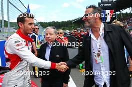 Jules Bianchi (FRA) Marussia F1 Team on the grid with Jean Todt (FRA) FIA President and Jean Reno (FRA) Actor. 22.06.2014. Formula 1 World Championship, Rd 8, Austrian Grand Prix, Spielberg, Austria, Race Day.