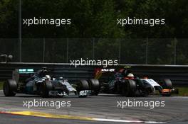 Lewis Hamilton (GBR) Mercedes AMG F1 W05 and Sergio Perez (MEX) Sahara Force India F1 VJM07 battle for position. 22.06.2014. Formula 1 World Championship, Rd 8, Austrian Grand Prix, Spielberg, Austria, Race Day.