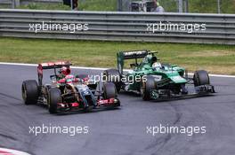 Romain Grosjean (FRA) Lotus F1 E22 and Marcus Ericsson (SWE) Caterham CT05. 22.06.2014. Formula 1 World Championship, Rd 8, Austrian Grand Prix, Spielberg, Austria, Race Day.