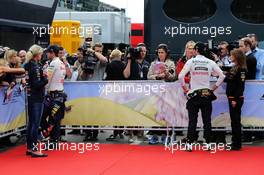 (L to R): Sebastian Vettel (GER) Red Bull Racing and Sergio Perez (MEX) Sahara Force India F1 with the media. 21.06.2014. Formula 1 World Championship, Rd 8, Austrian Grand Prix, Spielberg, Austria, Qualifying Day.
