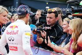 Sebastian Vettel (GER) Red Bull Racing with Will Buxton (GBR) NBS Sports Network TV Presenter and Jennie Gow (GBR) BBC Radio 5 Live Pitlane Reporter. 21.06.2014. Formula 1 World Championship, Rd 8, Austrian Grand Prix, Spielberg, Austria, Qualifying Day.