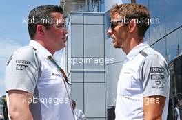 (L to R): Eric Boullier (FRA) McLaren Racing Director with Jenson Button (GBR) McLaren. 22.06.2014. Formula 1 World Championship, Rd 8, Austrian Grand Prix, Spielberg, Austria, Race Day.